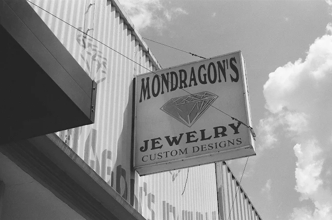 The Mondragon's Jewelry sign above the storefront in Rosenberg, Texas, lettered with a diamond and the words Custom Designs.